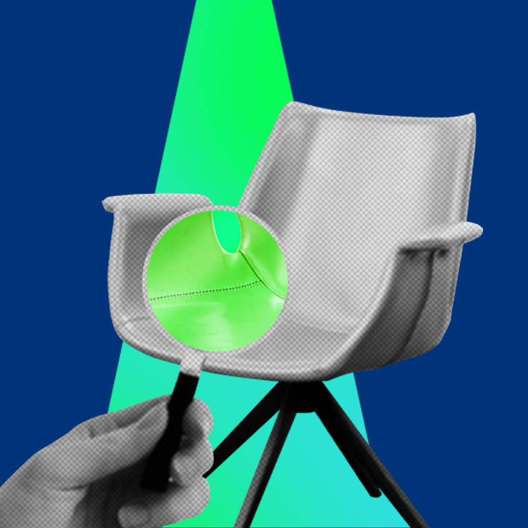 Chair and hand holding magnifying glass